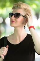 young woman with short blond hair and sunglasses photo