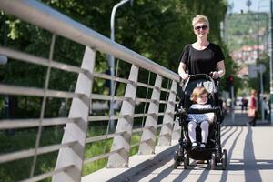 mother pushed her baby daughter in a stroller photo