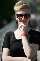 young woman with short blond hair and sunglasses photo