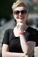 young woman with short blond hair and sunglasses photo