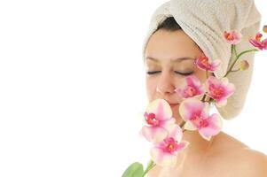beautiful young  woman face with flower and towel photo