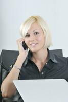 young business woman working in office on laptop photo