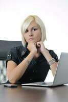 young business woman working in office on laptop photo