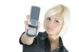 portrait of young blonde business woman holding new modern cellp photo