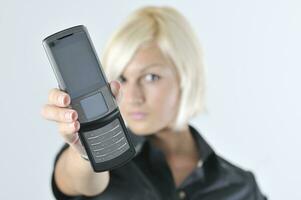 portrait of young blonde business woman holding new modern cellp photo