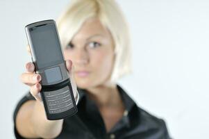 portrait of young blonde business woman holding new modern cellp photo