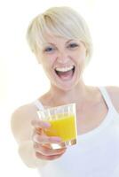 Young woman drinking orange juice isolated over white background photo