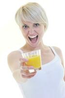 Young woman drinking orange juice isolated over white background photo