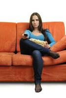 young woman eat popcorn and watching tv photo