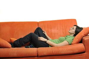 happy young woman relax on orange sofa photo