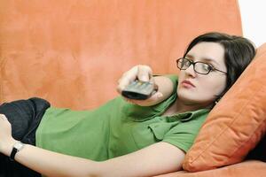 happy woman relax on orange sofa photo