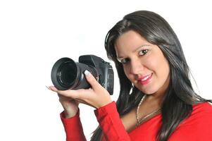 Young woman holding camera in hand taking picture isolated photo