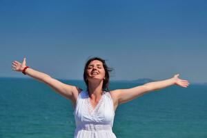 young woman with spreading arms to sky photo