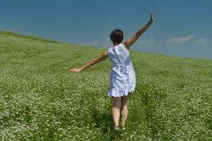 Young happy woman in green field photo