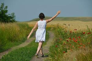 young woman in wheat field at summer photo