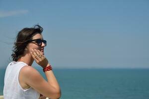 young woman with spreading arms to sky photo