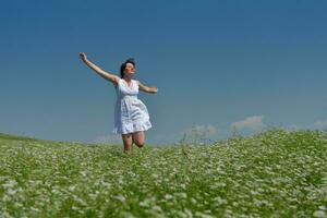 Young happy woman in green field photo