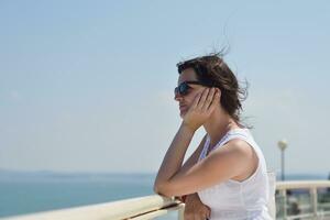 young woman with spreading arms to sky photo