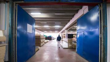 carpenter walking through factory photo