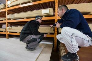 two young carpenters writing new prices photo