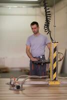 worker in a factory of wooden furniture photo