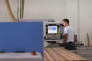 worker in a factory of wooden furniture photo