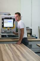 worker in a factory of wooden furniture photo