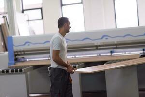 worker in a factory of wooden furniture photo