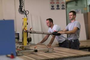 workers in a factory of wooden furniture photo