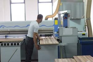 worker in a factory of wooden furniture photo