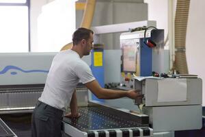 worker in a factory of wooden furniture photo