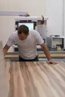 worker in a factory of wooden furniture photo