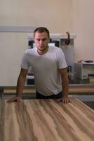 worker in a factory of wooden furniture photo