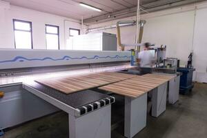 worker in a factory of wooden furniture photo