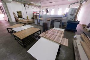 worker in a factory of wooden furniture photo