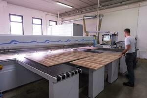 worker in a factory of wooden furniture photo