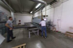 workers in a factory of wooden furniture photo