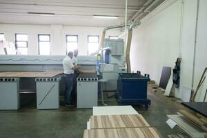 workers in a factory of wooden furniture photo