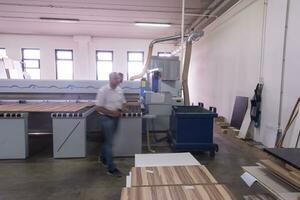 workers in a factory of wooden furniture photo