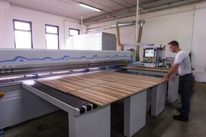 worker in a factory of wooden furniture photo