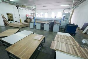 worker in a factory of wooden furniture photo