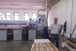 workers in a factory of wooden furniture photo