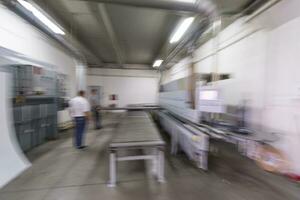 workers in a factory of wooden furniture photo