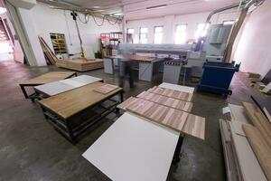 worker in a factory of wooden furniture photo