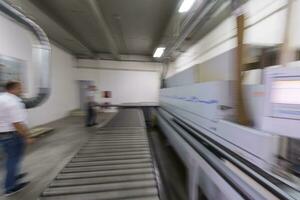 workers in a factory of wooden furniture photo