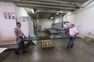 workers in a factory of wooden furniture photo