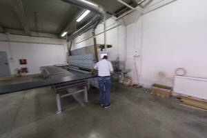 workers in a factory of wooden furniture photo