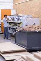 worker in a factory of wooden furniture photo