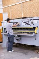 worker in a factory of wooden furniture photo