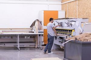 worker in a factory of wooden furniture photo